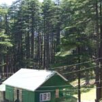 A serene mountain valley with cottages among greenery in places to visit near Patnitop.