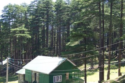 A serene mountain valley with cottages among greenery in places to visit near Patnitop.