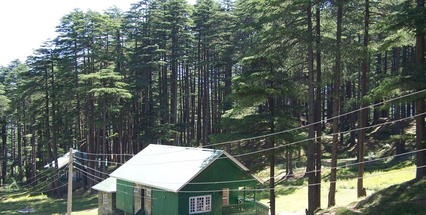 A serene mountain valley with cottages among greenery in places to visit near Patnitop.