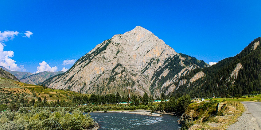 An enchanting view of a landscape with serene mountains and glimmering lakes in Kashmir