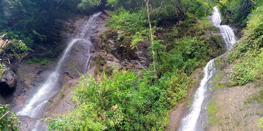 A scenic view of majestic falls surrounded by dense forests and vibrant foliage