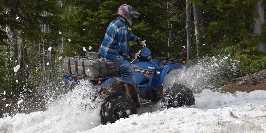 A man riding an ATV bike through snow, one of the best things to do in Doodhpathri.