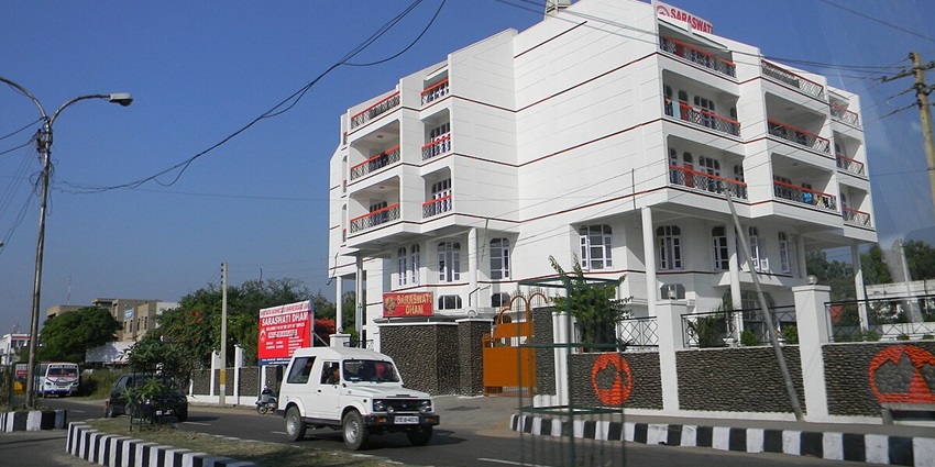 The view of a white hotel in Jammu - accommodation options available near Bhimgarh Fort