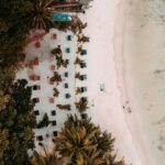 Aerial view of Andaman dotted with palm trees and chairs to soak up nature’s beauty.