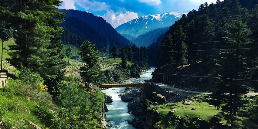 A mesmerising view of the Aharbal Waterfall with greenery around it, Pulwama in Kashmir.