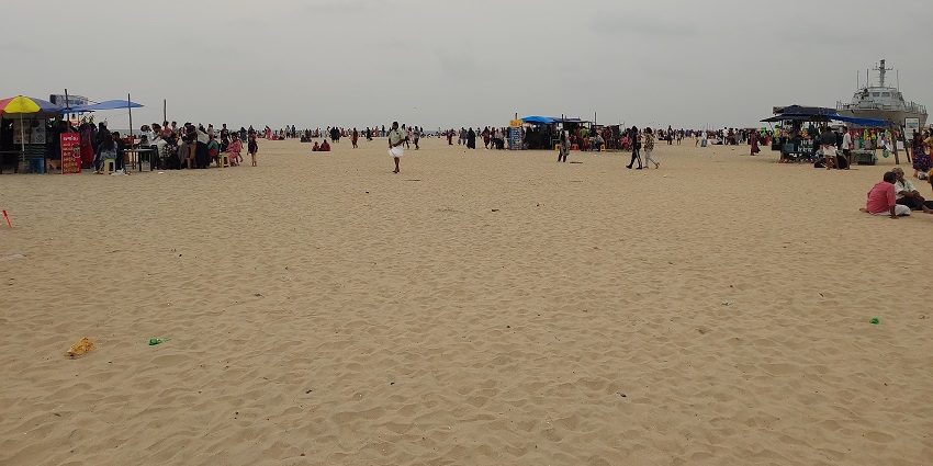 Alappuzha Beach with golden sands and a picturesque view of people enjoying at the beach.