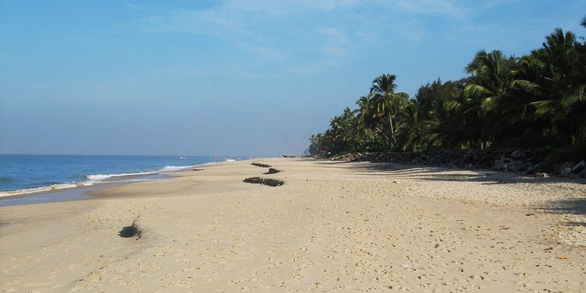 Scenic Alappuzha Beach with a historic pier stretching into the serene Arabian Sea.