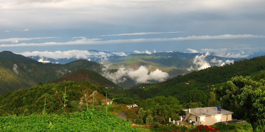 Captivating view of Almora in Uttarakhand with cloudy blue skies and lush green vegetation