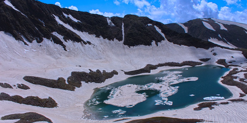 Alpather Lake is a bowl-shaped formation surrounded by wildflower-covered meadows.