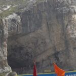 Sacred Amarnath Temple, housing a natural ice Shiva Lingam amidst rugged mountains.