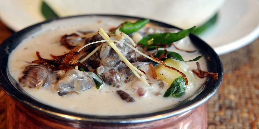 Appam , one of the best foods in Trivandrum, is a pancake served with stew.