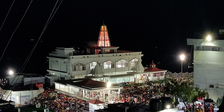 A night view of Ardhkunwari Temple with devotees resting in the open space outside