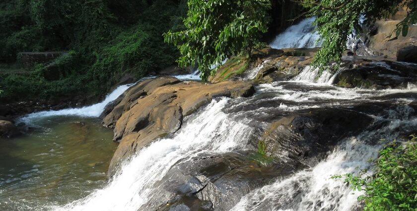 Enjoy a refreshing escape to Aruvikuzhy Waterfalls in Idukki amidst the lush landscapes.