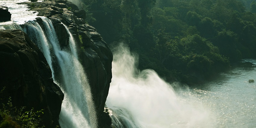 Top view of the silver water cascading down the rocks of Athirapally waterfalls