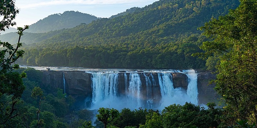 A beautiful waterfall with mountains in the background