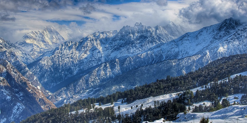 Snow covered mountain under blue sky during daytime - places to visit in winter in India