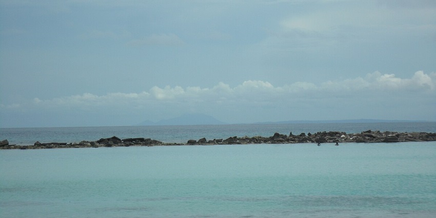 Ocean and the sky coming together at the beautiful Baby beach under the sunny sky