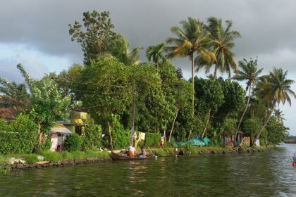 Beautiful Alleppey backwaters surrounded by greenery - places to visit in monsoon in India