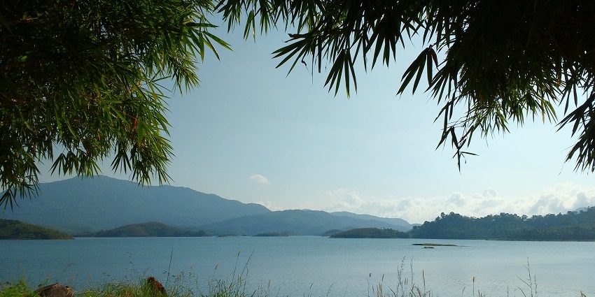 A spectacular view of Banasura Sagar Dam in Wayanad surrounded by lush greenery.