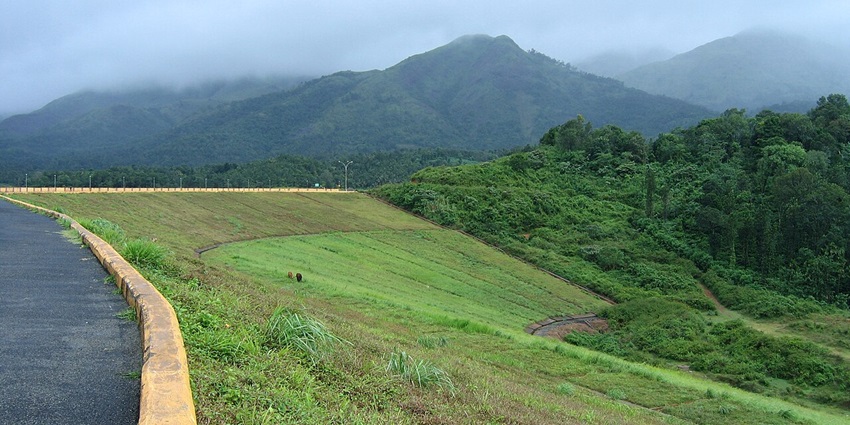 Expansive reservoir of Banasura Sagar Dam framed by lush hills and islands.