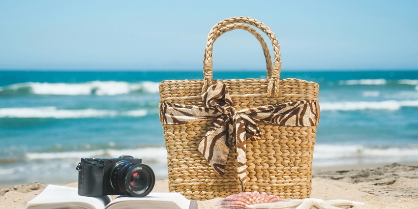 Picture of a beach basket, book, and camera for carrying your beach necessities