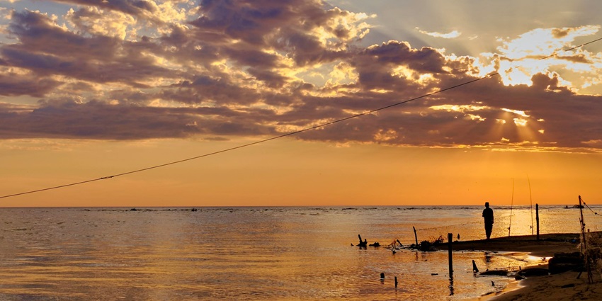 Evening beach with its gorgeous clouds and clear water, featuring stunning views