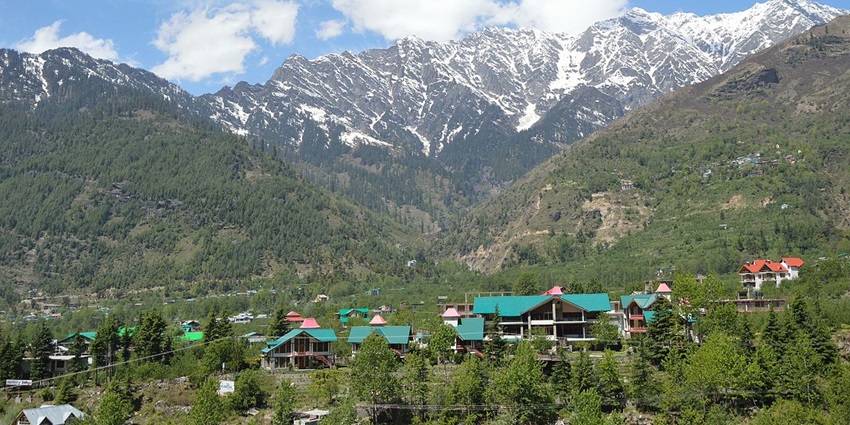 Scenic view of the forested Beas valley overlooking the snow covered mountain beyond