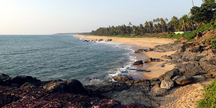 Serene Bekal Beach with its sandy shores and the iconic Bekal Fort in the distance.