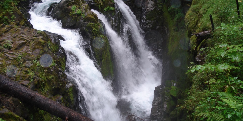 A beautiful waterfall cascading through the green hills