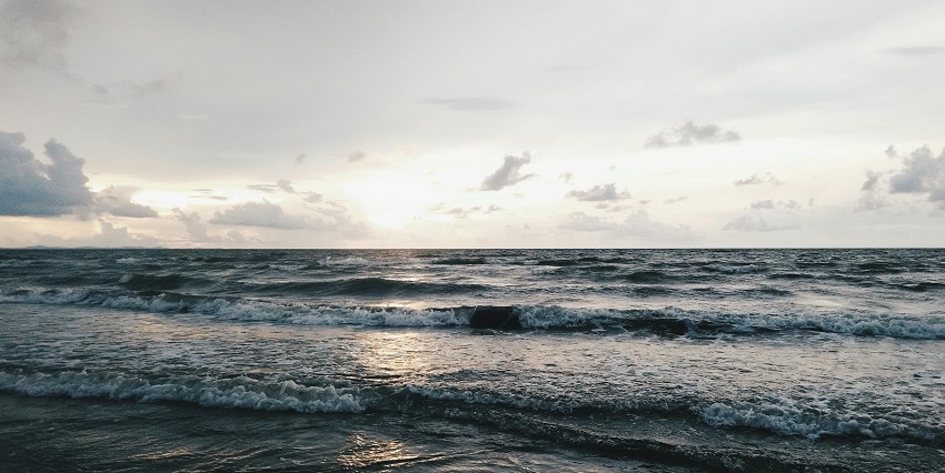 A view of an island with sea waves which is the best time to visit Rutland Island.