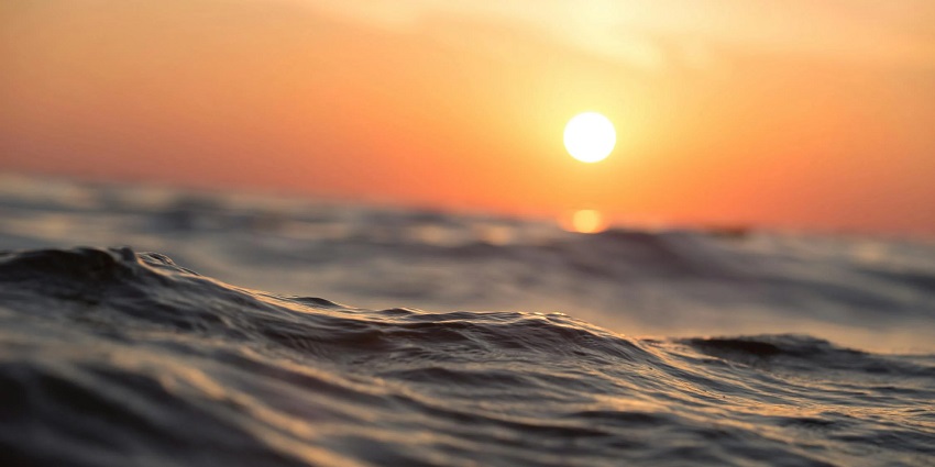 A view of a water body during sunset, perfect time to visit Corbyn’s Cove Beach.