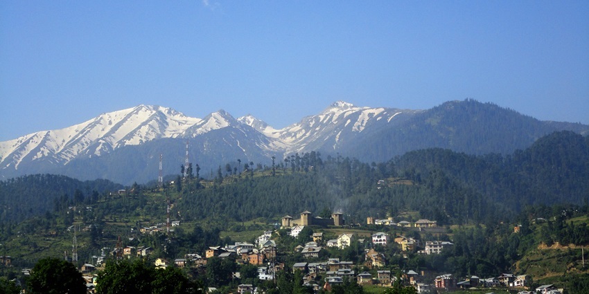 The beauty of Bhaderwah with cloudy blue skies and dense forests captured in a picture