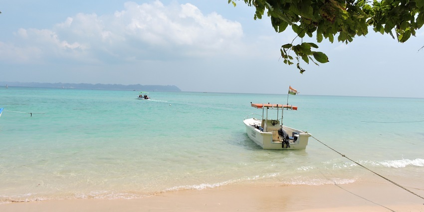 Go on a boat ride to explore the stunning coral reefs of Bharatpur Beach in Port Blair