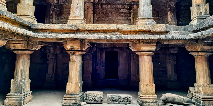 A picture of a historical temple in Srinagar with intricate carvings on its pillars