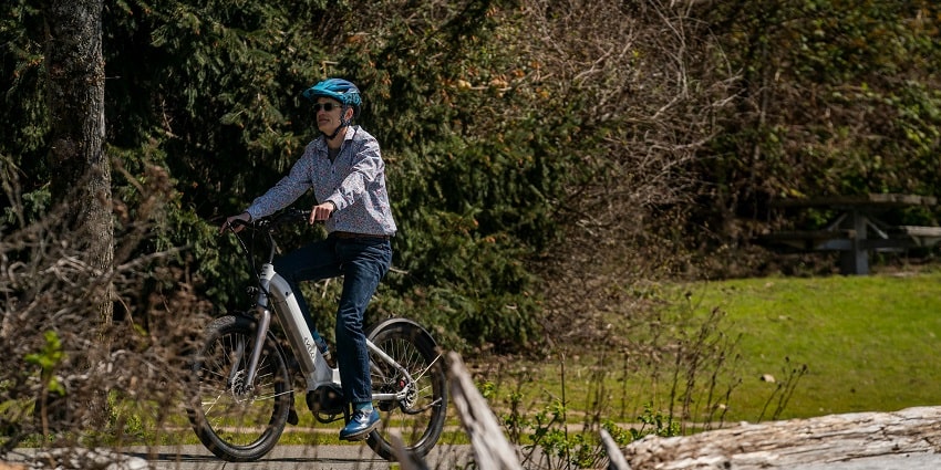 A person riding a bike on a trai, lush green surroundings - things to do in Kullu