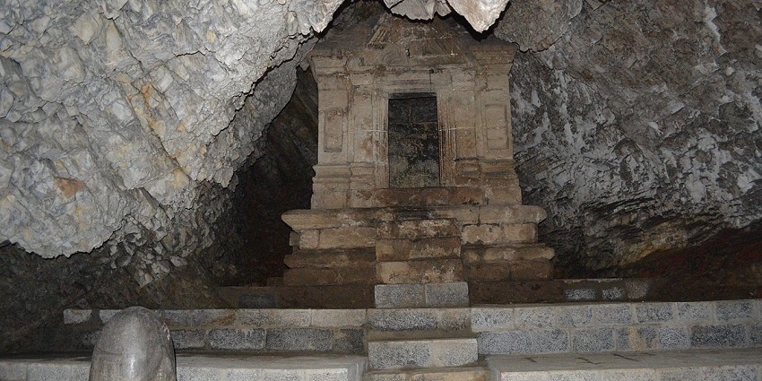 Historic Bumzuva Cave Temple, set within a rocky landscape and surrounded by nature.