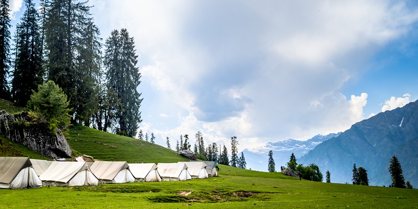 Camp surrounded by lush greenery and majestic mountain views - things to do in Kasol