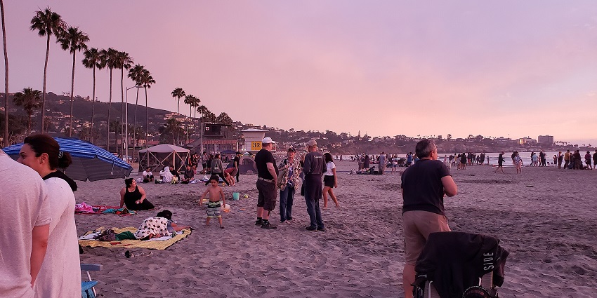 Lively atmosphere on the island, with people camping and lighting up the bonfire.