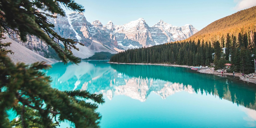 A breathtaking view of the famous Moraine Lake with snow-clad peaks in Alberta, Canada