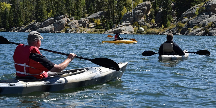 Canoeing in the river, gliding through calm waters surrounded by nature.