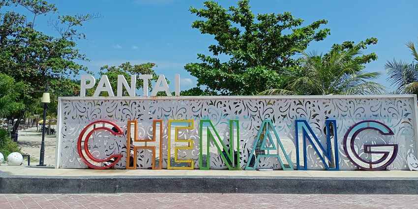 Pantai Cenang beach in Langkawi with soft sands, turquoise waters, and vibrant beach activities.