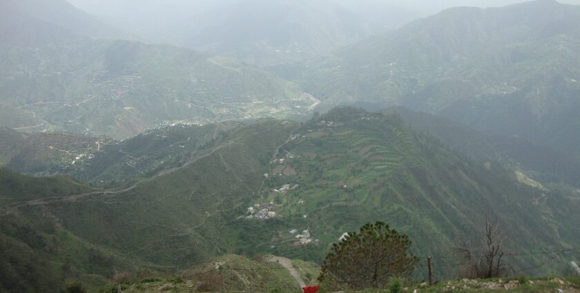 Aerial view of the Small city of Chail amidst the lush green forest surrounding the city