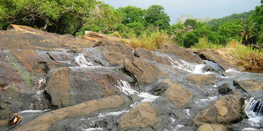 Chalakudy river view cascading water through rocks - visit Chalakudy waterfalls Kerala