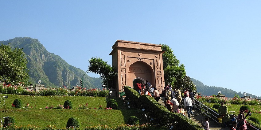 Chashme Shahi Garden: cascading waterfalls, lush greenery, and Mughal architecture