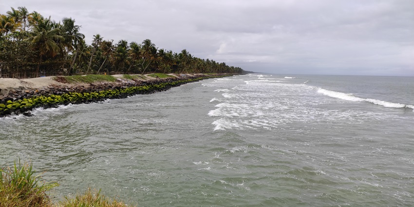 Waves crashing against rocky shorelines at Chellanam Beach, a serene fishing village coast.