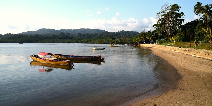 A picture of a scenic lake in Port Blair with a lush green island visible in the background