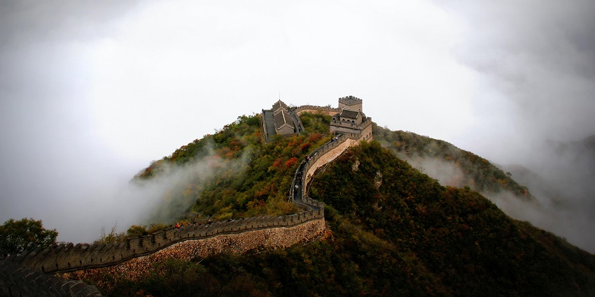 A captivating aerial view of the fascinating Great Wall of China surrounded by clouds