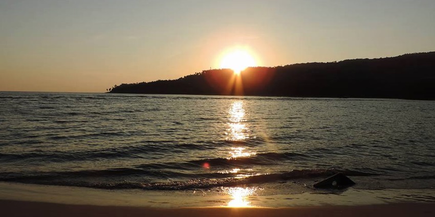 The beautiful sunset view from the sandy shores of Choottad beach in Kannur, Kerala