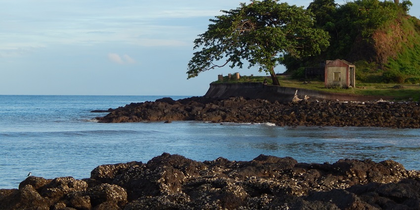 A view of the tranquil waters of Port Blair with rocky edges of an island visible in the background