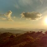 A stunning view of Mathikettan Shola Park in Kerala during sunset covered with dense clouds.